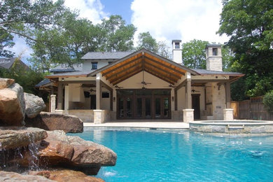 Large tuscan backyard stone and custom-shaped natural pool fountain photo in Houston