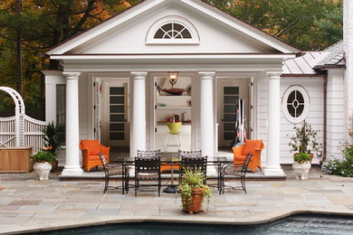 Large elegant backyard stone and rectangular pool house photo in New York