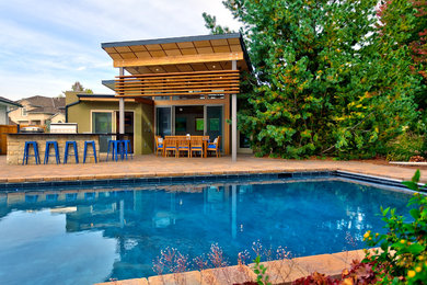 Trendy backyard rectangular pool house photo in Boise
