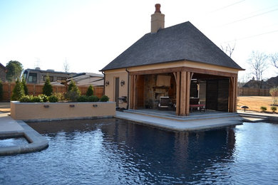 This is an example of a large back custom shaped lengths swimming pool in Other with a pool house.