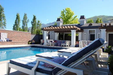 Example of a mid-sized transitional backyard custom-shaped pool house design in Salt Lake City