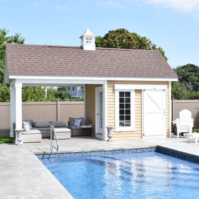 Mid-sized transitional backyard custom-shaped and concrete paver pool house photo in Boston