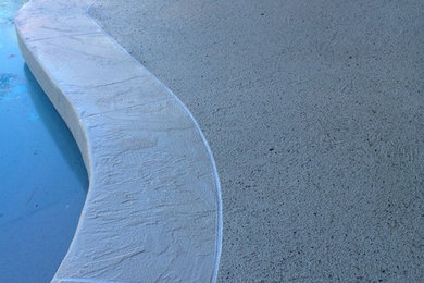 Pool - mid-sized modern backyard concrete and custom-shaped pool idea in Miami