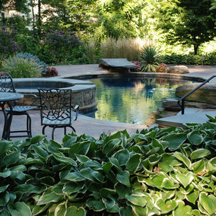 Large country backyard custom-shaped natural pool in New York with a hot tub and decomposed granite.