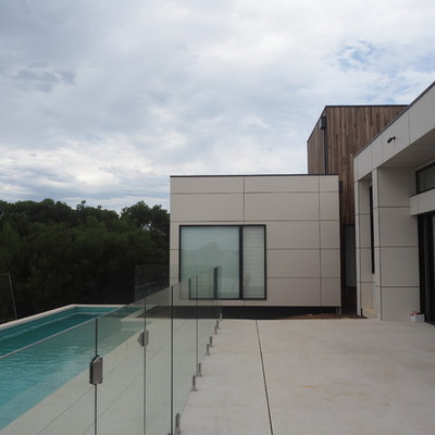 Inspiration for a mid-sized modern backyard concrete paver and rectangular lap pool house remodel in Geelong
