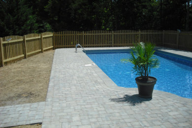 Pool - large concrete paver and custom-shaped lap pool idea in DC Metro
