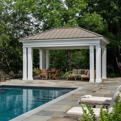 Inspiration for a mid-sized transitional backyard stone and rectangular pool remodel in New York