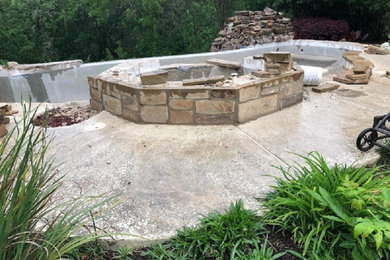 Mid-sized arts and crafts backyard stone and custom-shaped lap hot tub photo in Austin