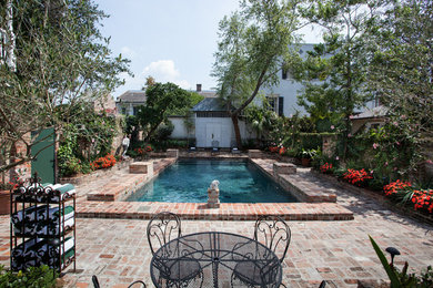 Inspiration for a mid-sized timeless backyard brick and rectangular pool remodel in New Orleans