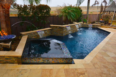Pool fountain - mid-sized contemporary backyard tile and custom-shaped pool fountain idea in New Orleans