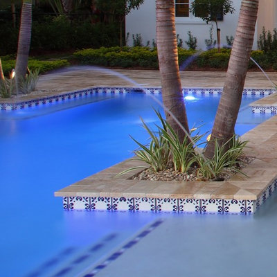 Pool fountain - large mediterranean backyard stone and custom-shaped lap pool fountain idea in Sacramento