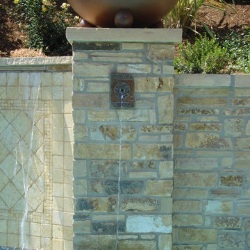 Pool wall with copper spill way and fire bowl.