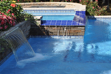 This is an example of a contemporary swimming pool in Philadelphia with a water feature.