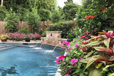 Example of a classic backyard stone pool fountain design in New Orleans