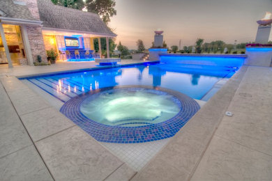 Inspiration for a large transitional backyard concrete paver and rectangular natural hot tub remodel in Cedar Rapids