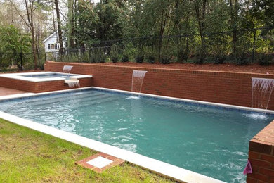 Pool fountain - mid-sized craftsman backyard brick and rectangular natural pool fountain idea in Atlanta