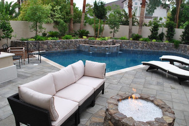 Inspiration for a mid-sized modern backyard stone and custom-shaped natural pool fountain remodel in Las Vegas