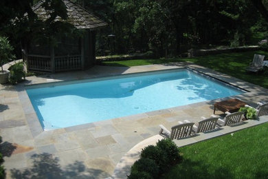 Pool house - large traditional backyard stamped concrete and rectangular lap pool house idea in Minneapolis