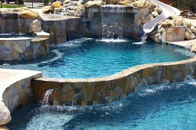 Example of a large mountain style backyard custom-shaped and concrete natural water slide design in Sacramento