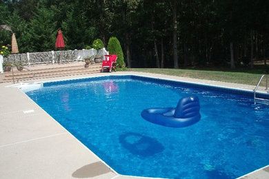 Pool fountain - large traditional backyard concrete paver and custom-shaped lap pool fountain idea in Philadelphia