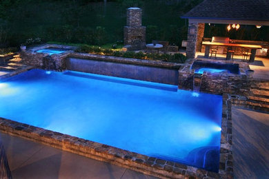Hot tub - large mediterranean backyard stone and rectangular lap hot tub idea in Houston