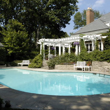 Pools with stone and pergola patio design in Winnetka, IL.