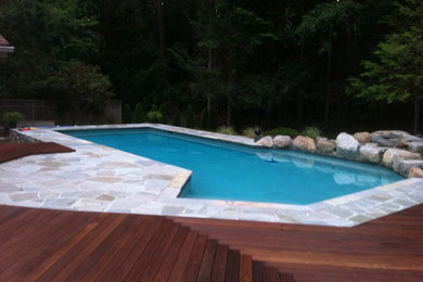 Inspiration for a contemporary custom-shaped pool remodel in New York with decking