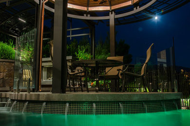 Poolside dining area with canopy and water feature