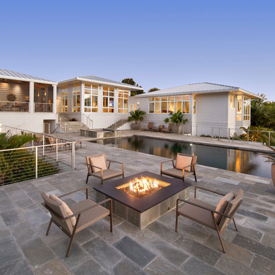 Hot tub - large tropical backyard stone and rectangular aboveground hot tub idea in Detroit