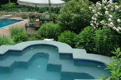 Hot tub - mid-sized traditional backyard brick and rectangular lap hot tub idea in New York