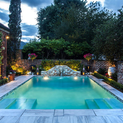Pool fountain - small transitional courtyard concrete paver and rectangular lap pool fountain idea