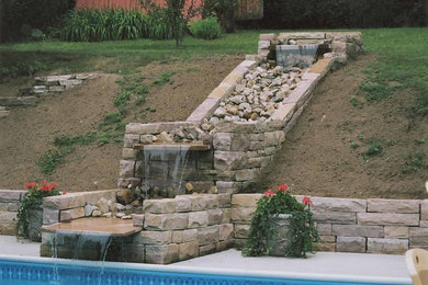 Large elegant backyard stone and rectangular lap pool fountain photo in Burlington