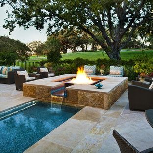 Example of a tuscan backyard stone and rectangular lap pool design in Dallas