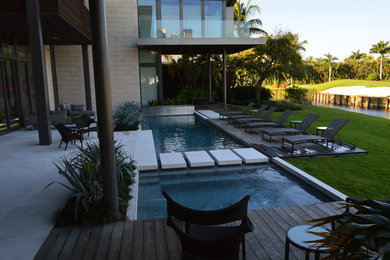 Inspiration for a huge contemporary backyard stone and rectangular lap hot tub remodel in Miami