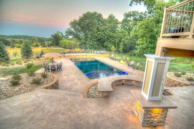 Pool - large transitional backyard concrete paver and rectangular natural pool idea in Cedar Rapids