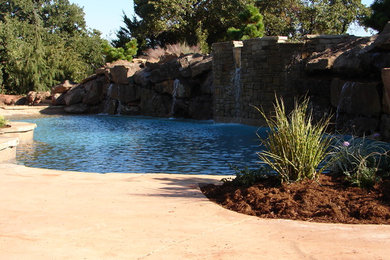Pool fountain - mid-sized traditional backyard stone and kidney-shaped lap pool fountain idea in Oklahoma City