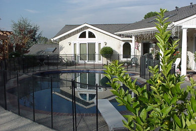 Design ideas for a medium sized classic back custom shaped natural swimming pool in San Francisco with brick paving.