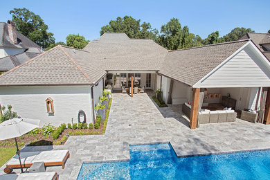 Imagen de casa de la piscina y piscina natural contemporánea de tamaño medio rectangular en patio trasero con adoquines de piedra natural