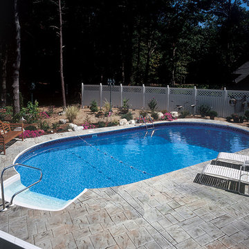 Radiant Oval In Ground Pool with Step and Stamped Concrete