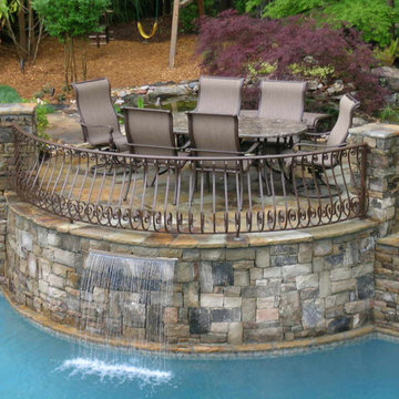 Raised Patio surrounded by a natural waterfall and pond