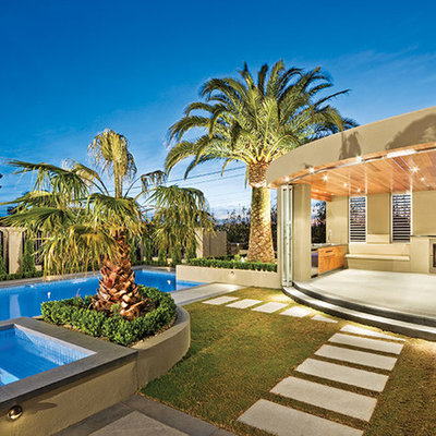 Inspiration for a large mediterranean backyard concrete paver and rectangular lap hot tub remodel in Orange County