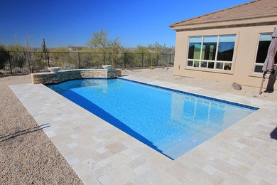 Pool - mid-sized backyard stone and rectangular pool idea in Phoenix