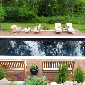 Red clay pool deck with Valders Stone coping