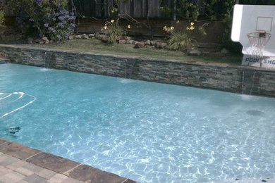 Example of a mid-sized backyard concrete paver and rectangular pool design in San Francisco