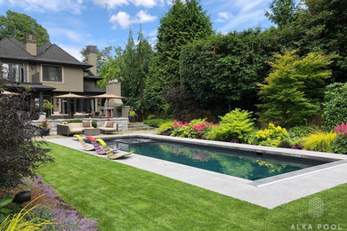 Elegant backyard rectangular hot tub photo in Vancouver