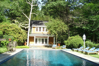 Design ideas for a large traditional back rectangular lengths swimming pool in New York with a pool house.