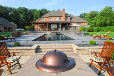 Inspiration for a large modern backyard stone and rectangular natural hot tub remodel in Boston
