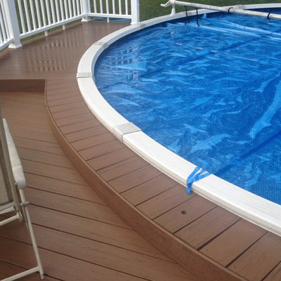 Inspiration for a mid-sized timeless backyard round pool remodel in Detroit with decking