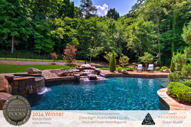 Example of a backyard stone and custom-shaped pool design in Nashville
