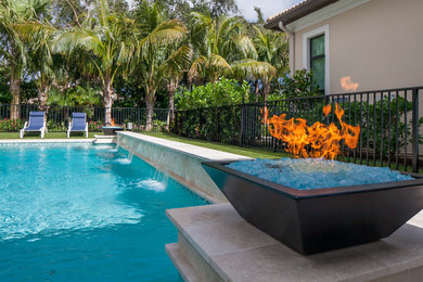 This is an example of a large classic back custom shaped lengths hot tub in Miami with concrete paving.